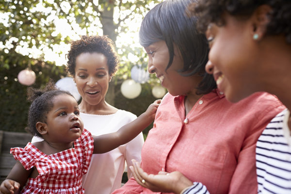 Multi generation female family members gathered in a garden